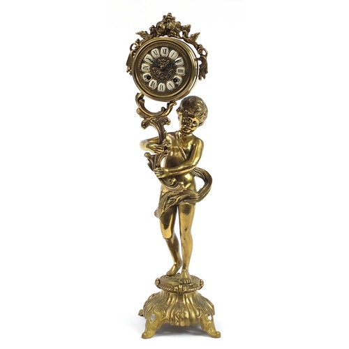 1267 - Large ornate brass mantle clock in the form of a semi nude boy holding an acanthus leaf, the dial ha... 