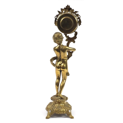 1267 - Large ornate brass mantle clock in the form of a semi nude boy holding an acanthus leaf, the dial ha... 