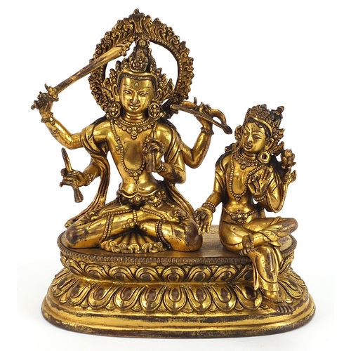 90 - Chino Tibetan gilt bronze figure of two deities sitting on a lotus leaf, 16cm wide