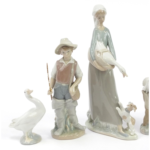 556 - Six Lladro figures and animals including a boy with bird and girl with doves, the largest 28.5cm hig... 