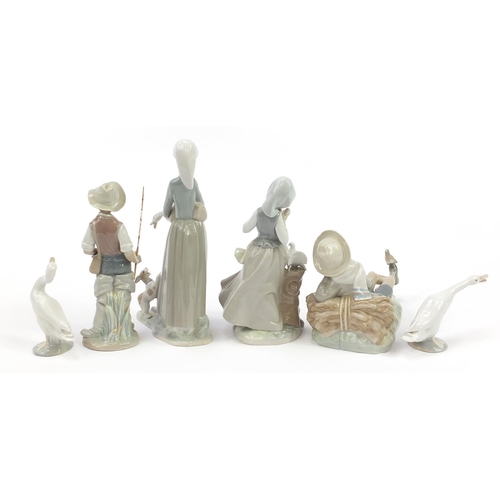 556 - Six Lladro figures and animals including a boy with bird and girl with doves, the largest 28.5cm hig... 