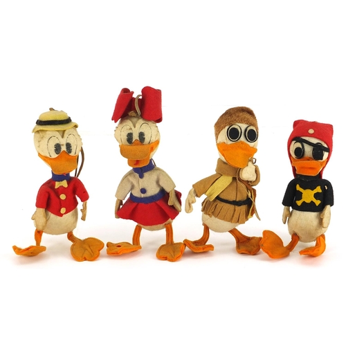 1351 - Four vintage Disney style duck toys, the largest 16cm high