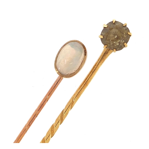 1975 - Two gold stickpins comprising one 9ct gold set with a cabochon opal and one unmarked gold set with a... 