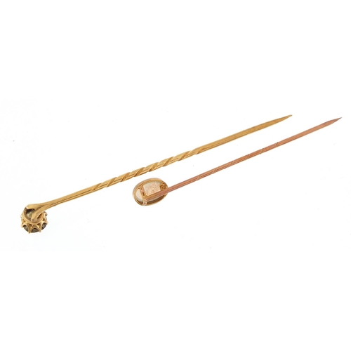 1975 - Two gold stickpins comprising one 9ct gold set with a cabochon opal and one unmarked gold set with a... 