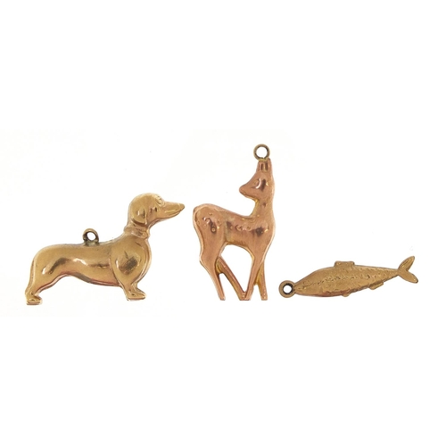 1674 - Three 9ct gold charms comprising Dachshund, deer and fish, the largest 2.5cm in length, total 3.8g