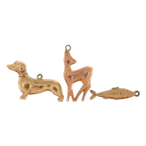 1674 - Three 9ct gold charms comprising Dachshund, deer and fish, the largest 2.5cm in length, total 3.8g