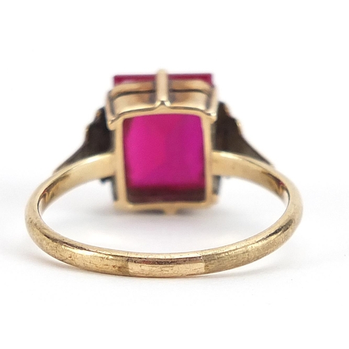 1722 - 9ct gold pink stone ring with stepped shoulders, (tests as ruby) size Q, 3.3g