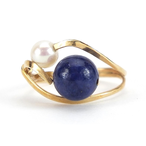 1904 - Unmarked gold lapis lazuli and pearl crossover ring, (tests as 9ct gold) size I, 2.1g