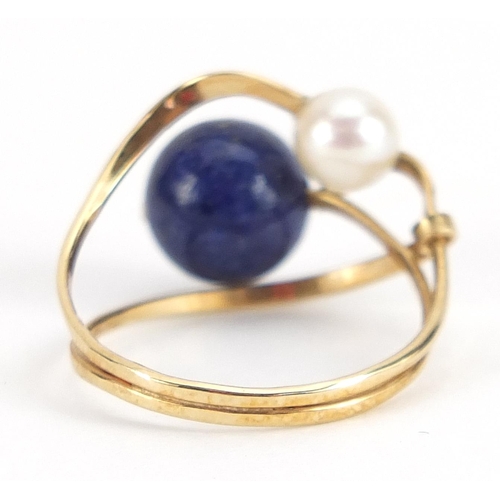 1904 - Unmarked gold lapis lazuli and pearl crossover ring, (tests as 9ct gold) size I, 2.1g