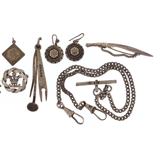 2025 - Silver and white metal jewellery including a watch chain with T bar, sports jewel and Gurkha's kukri... 