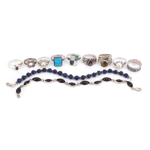 2084 - Nine silver and white metal rings and two bracelets, some set with semi precious stones, total weigh... 