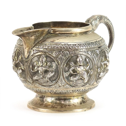 2245 - Indian unmarked silver cream jug with elephant head handle relief decorated with deities, 7.5cm high... 