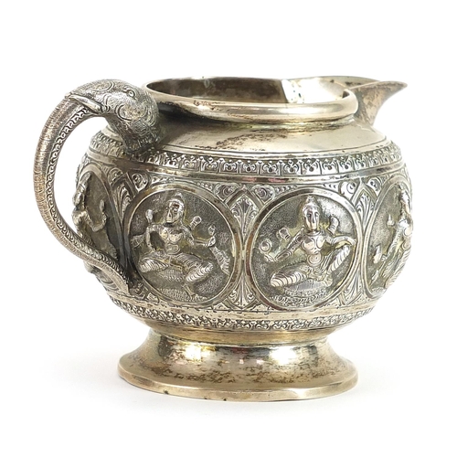 2245 - Indian unmarked silver cream jug with elephant head handle relief decorated with deities, 7.5cm high... 