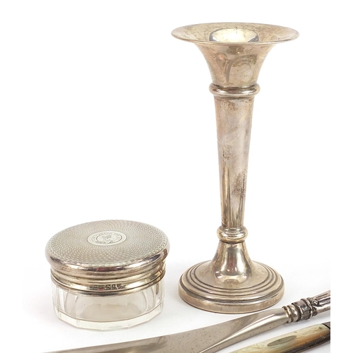 2260 - Silver objects including trumpet shaped bud vase, two mother of pearl flanked folding fruit knives a... 