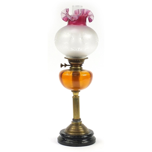 1268 - Victorian brass oil lamp with amber glass reservoir and  cranberry glass shade, 63cm high