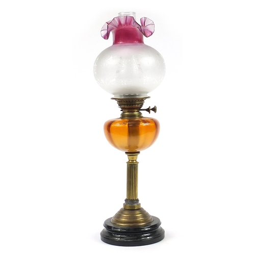 1268 - Victorian brass oil lamp with amber glass reservoir and  cranberry glass shade, 63cm high