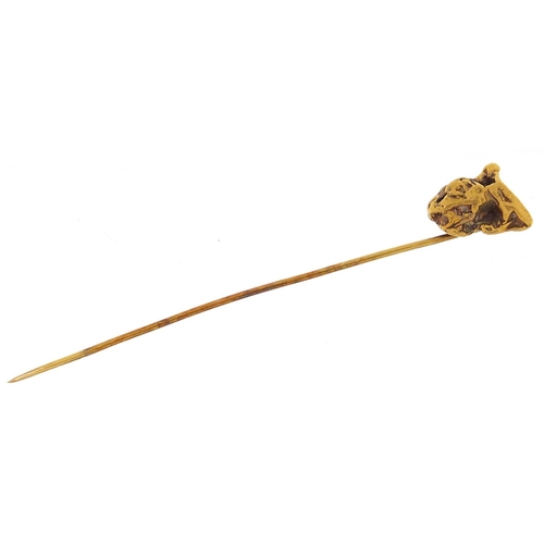 2077 - Unmarked gold nugget stickpin mounted on a Dawson Y.T card, 6.5cm high, 2.5g