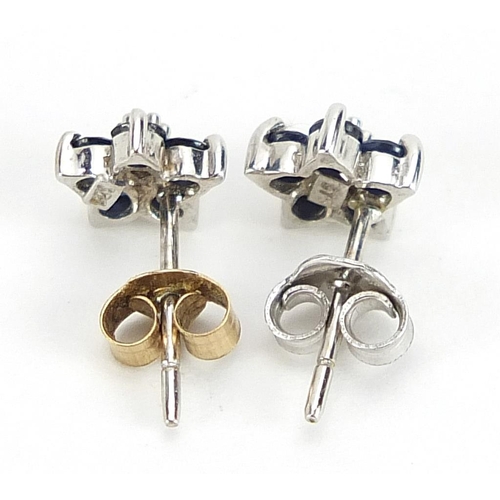 1953 - Pair of 9ct white gold diamond and sapphire flower head stud earrings, 7mm high, 0.8g