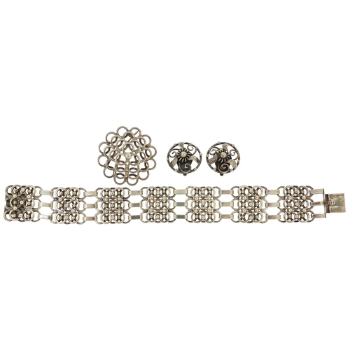 1952 - Hermann Siersbol, Danish 830S silver bracelet, matching brooch and a pair of similar earrings, the b... 