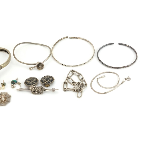 2049 - Silver and white metal jewellery including a marcasite crown brooch, oval locket, bangles and neckla... 