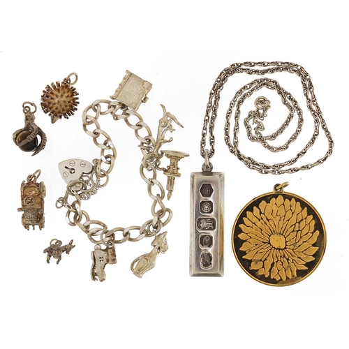 2081 - Silver jewellery comprising charm bracelet, loose charms, ingot pendant on necklace and silver gilt ... 