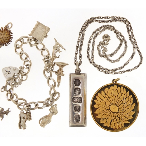 2081 - Silver jewellery comprising charm bracelet, loose charms, ingot pendant on necklace and silver gilt ... 