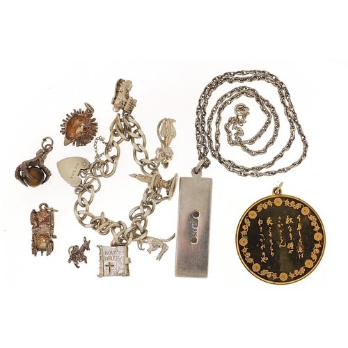 2081 - Silver jewellery comprising charm bracelet, loose charms, ingot pendant on necklace and silver gilt ... 