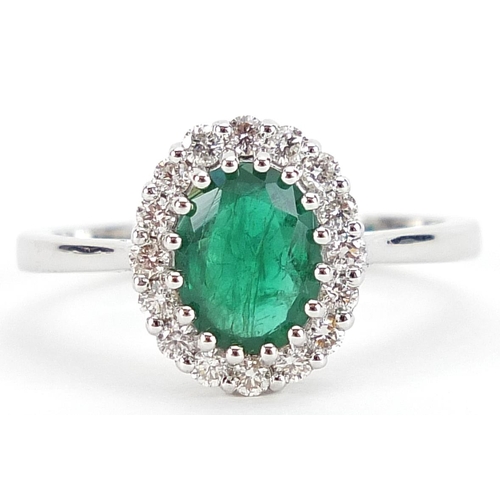 1684 - 18ct white gold emerald and diamond cluster ring, the emerald approximately 1.11 carat, total diamon... 