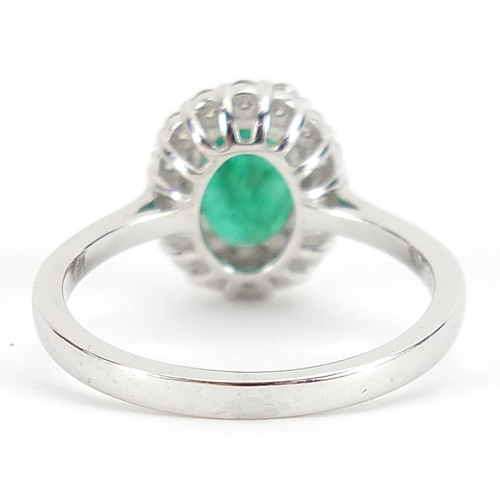 1684 - 18ct white gold emerald and diamond cluster ring, the emerald approximately 1.11 carat, total diamon... 