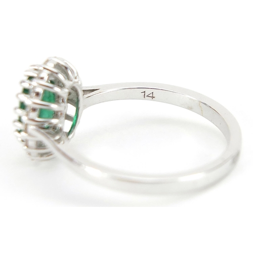 1684 - 18ct white gold emerald and diamond cluster ring, the emerald approximately 1.11 carat, total diamon... 