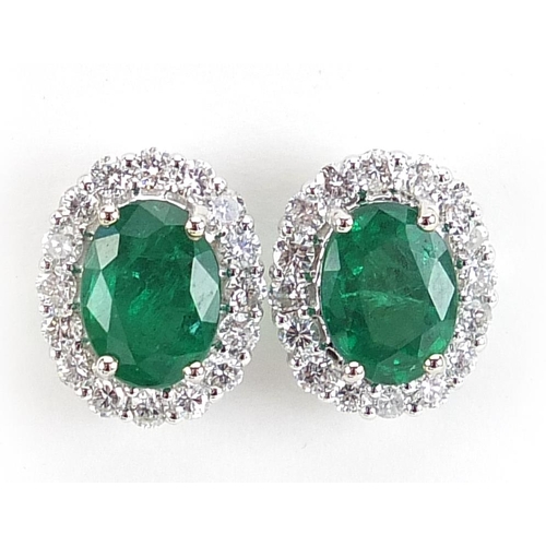 1840 - Pair of 18ct white gold emerald and diamond cluster stud earrings, total emerald weight approximatel... 