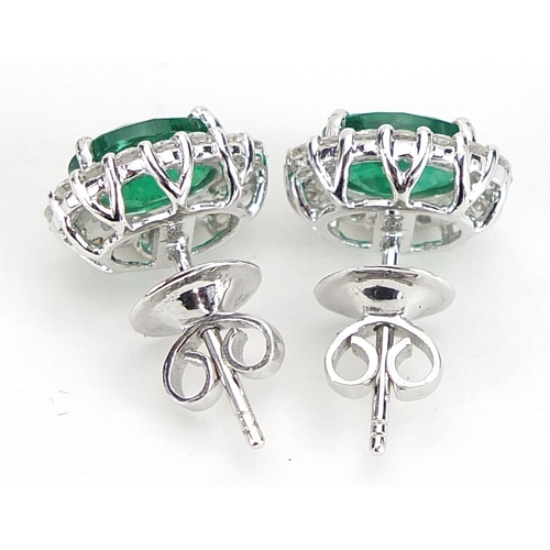 1840 - Pair of 18ct white gold emerald and diamond cluster stud earrings, total emerald weight approximatel... 