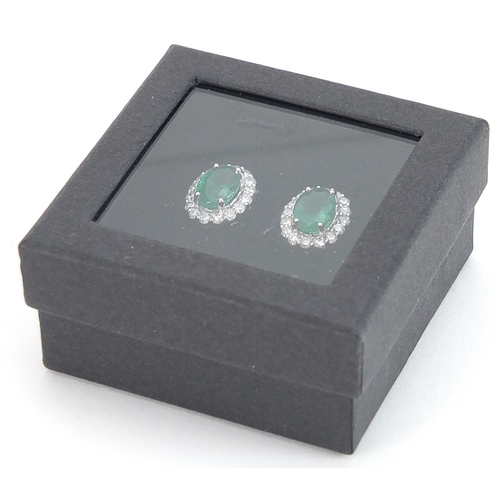 1840 - Pair of 18ct white gold emerald and diamond cluster stud earrings, total emerald weight approximatel... 