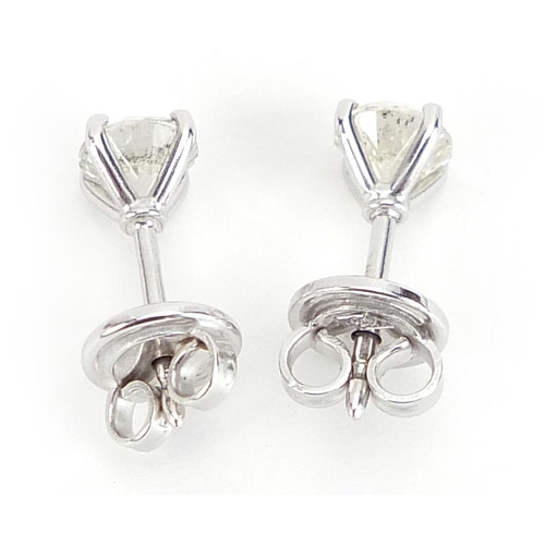 1672 - Pair of 18ct white gold diamond solitaire stud earrings, total diamond weight approximately 1.04 car... 