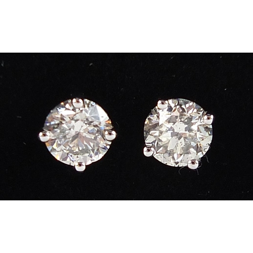 1672 - Pair of 18ct white gold diamond solitaire stud earrings, total diamond weight approximately 1.04 car... 