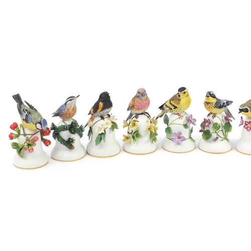 548 - Ten Franklin Mint porcelain bird bells by Peter Barrett, the largest 14cm high