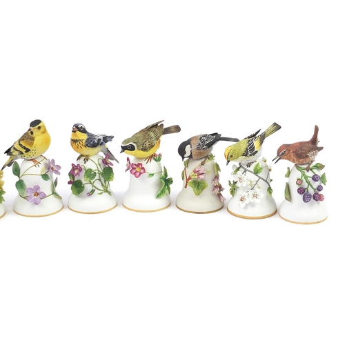 548 - Ten Franklin Mint porcelain bird bells by Peter Barrett, the largest 14cm high