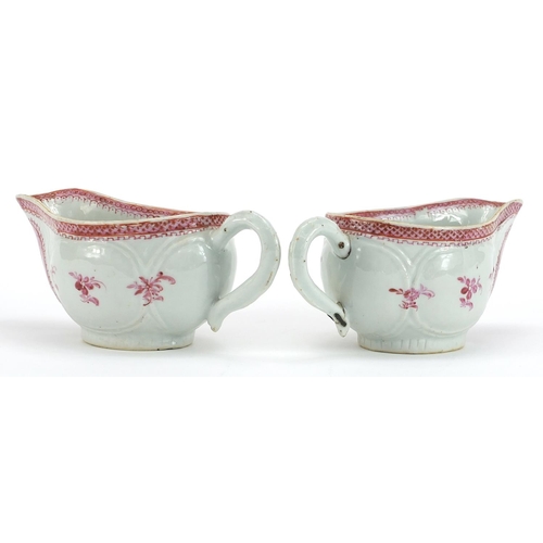 84 - Pair of Chinese porcelain pink monochrome sauce boats hand painted with flowers, each 19cm in length