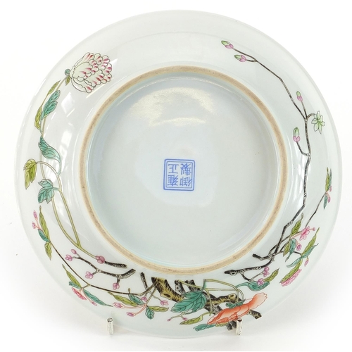 293 - Chinese porcelain shallow dish hand painted in the famille rose palette with flowers, four figure ch... 