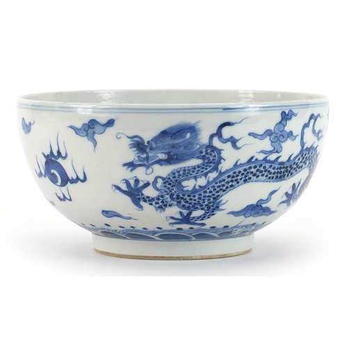 292 - Chinese blue and white porcelain bowl hand painted with dragons chasing a flaming pearl amongst clou... 