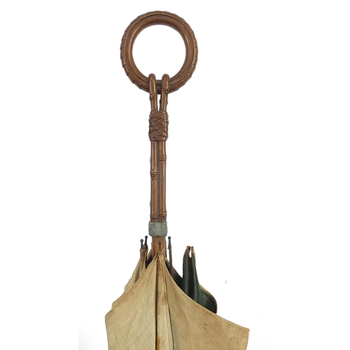 1252 - Black forest parasol with carved bamboo design handle, 87cm in length