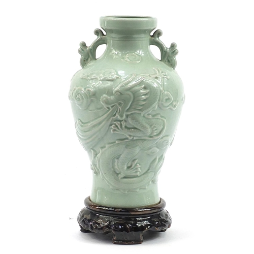 344 - Large Chinese porcelain vase on stand with twin handles having a celadon glaze, decorated in relief ... 