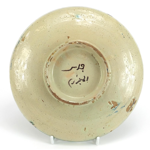 674 - Islamic pottery footed dish hand painted with flowers, 22cm in diameter