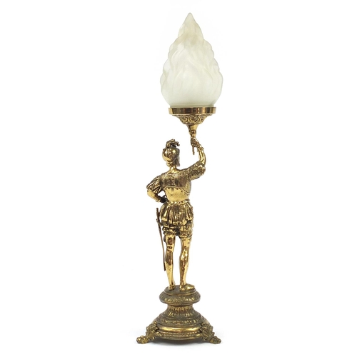 1229 - Ornate brass table lamp with frosted flame glass shade in the form of a soldier wearing 17th century... 