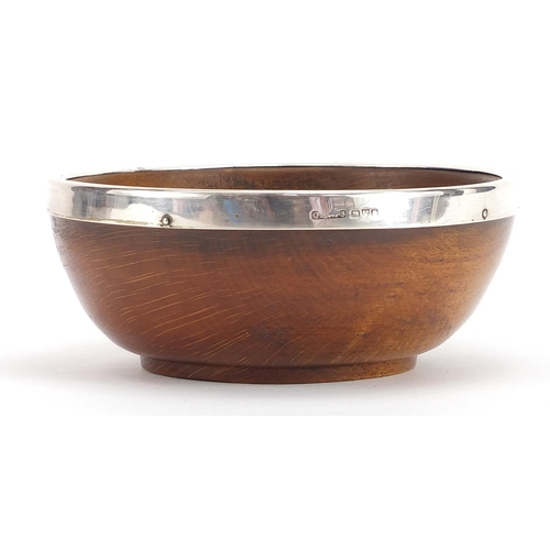 675 - Treen bowl with silver rim, indistinctly hallmarked Chester, 13.5cm in diameter