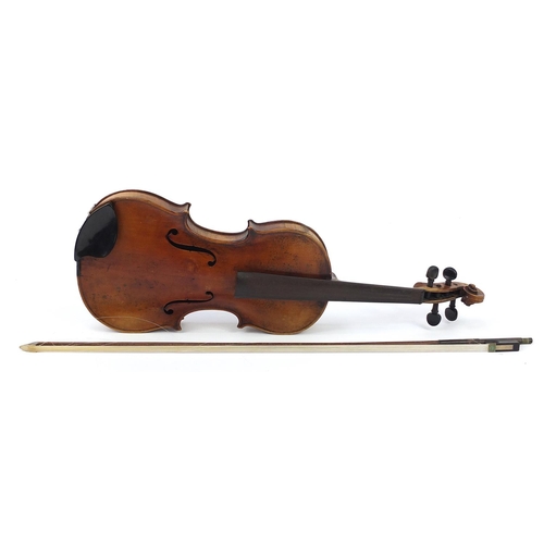 411A - German violin with two piece back, bow and case, the violin bearing a Stradivarius paper label, the ... 