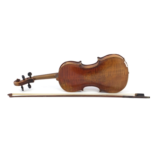 411A - German violin with two piece back, bow and case, the violin bearing a Stradivarius paper label, the ... 