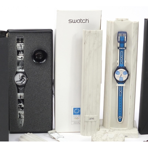 2198 - Swatch, five Swatch Olympic wristwatches in three  sets with boxes and cases