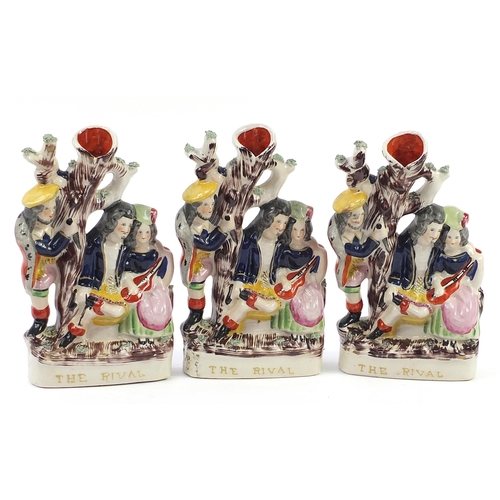 1069 - Three Staffordshire style flatback figural vases, each titled The Rival, each 30cm high