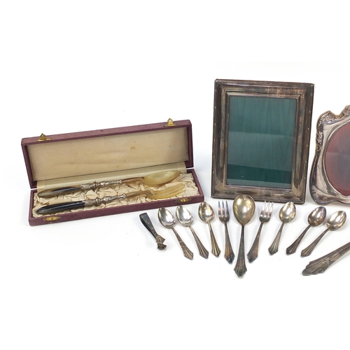 687 - Silver plated sundry items including WMF cutlery, butter dish with lobster knop and two easel photo ... 